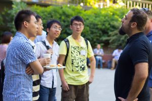 students talking to professor outdoors