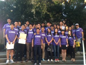 group photo of students wearing matching purple shirts