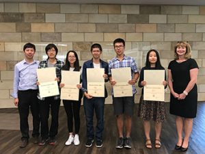 students holding certificates